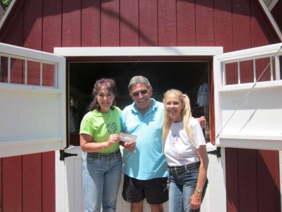Artist donates $1,000 to shelter small critters Photo by Roger Gavan Posing in front of the new "mini barn," from left: Suzyn Barron, president of the Warwick Valley Humane Society; Ron Genovese; and Lee Peterson, the humane society's corresponding secretary.