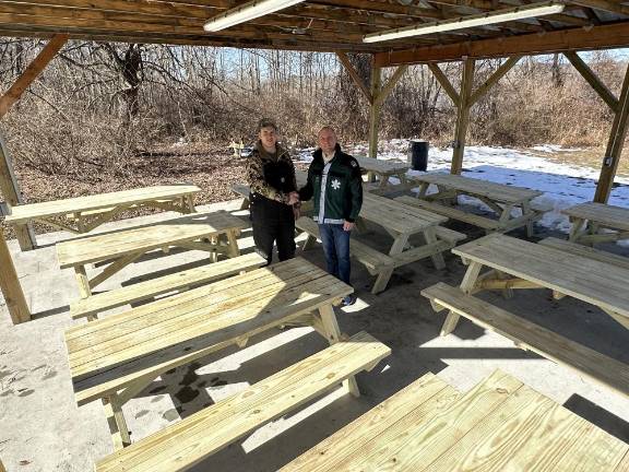 Travis Coleman and Warwick Town Supervisor Jesse Dwyer stand in the pavillion with the table donations.