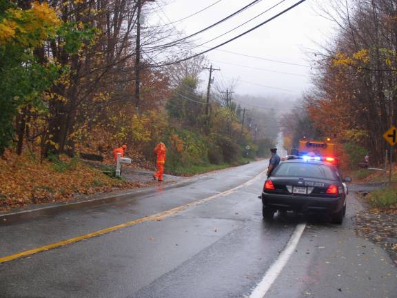 Hurrican Sandy rips through Orange County Police keep arwick DPW workers safe as they clear storm drains to prepare for Sandy.