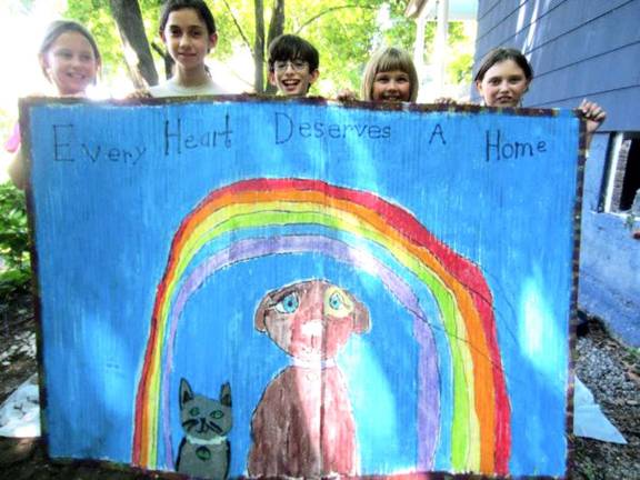 Moving Company Art students donate project to Warwick Valley Humane Society Young students enrolled in the Moving Company Modern Dance Center summer arts program recently donated a colorful bamboo rug to the Warwick Valley Humane Societyís animal shelter. From left: Annabel Boland, Emma Jakubik, Jonah Bowen, Grace Haesche and Gwen Haesche.