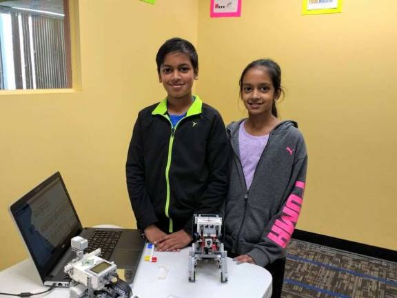Kids become engineers at Robotics4U Ashok and Swathi Sathiyamoorthy with their robot Puppy (Photo by Ginny Privitar)