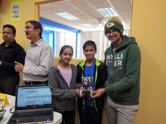 Kids become engineers at Robotics4U Swathi and Ashok Sathiyamoorthy with Ronan Patel (Photo by Ginny Privitar)