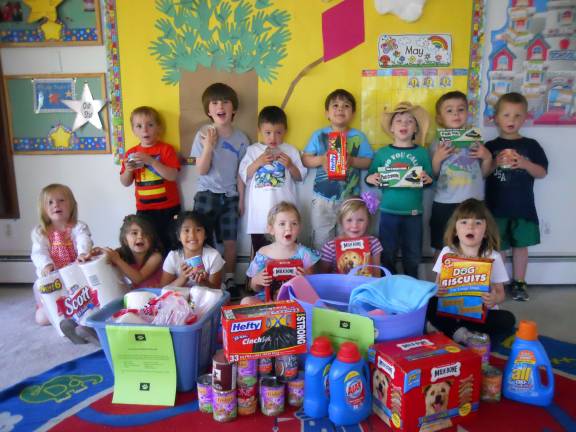 Creative Kids pre-schoolers, parents donate supplies for animal shelter Creative Kids pre-schoolers with supplies collected for the Warwick Valley Humane Societyís animal shelter.