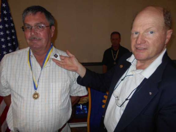 Leo Kaytes, Jr. heads Warwick Rotary Club John Bollenbach, left, receives a pin symbolizing his becoming Warwick Valley Rotary’s first major donor to Rotary International. Dr. Edwin Wiley, Warwick’s Rotary Foundation Chair, makes the presentation during the local club’s installation dinner.