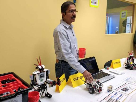 Kids become engineers at Robotics4U Vivek Sinha demonstrated a robot (Photo by Ginny Privitar)