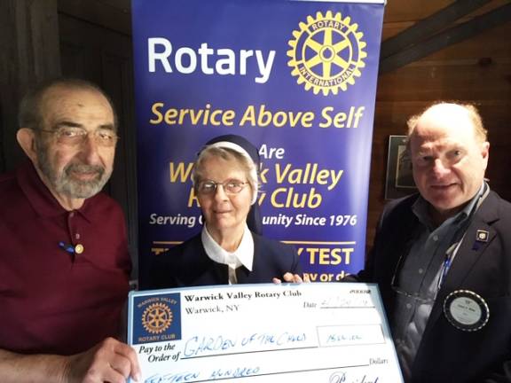 Warwick Rotarians support Garden of Child with 30 consecutive yearly donations Photo by Chris Olert Garden of the Child founder Sister Anna Roche accepts the organization’s 30th annual contribution from the Warwick Valley Rotary Club. Leo Kaytes, left, helped promote the start-up efforts in 1989 when he was Rotary president. Since then Warwick Rotarians have donated more than $30,000 to Garden of the Child, an early childhood/middle school detection, intervention and prevention program. Warwick Rotary President Ed Wiley made the $1,500 check presentation.