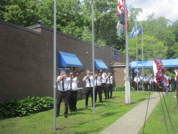 American Legion ceremony honors departed comrades Honor Guard gives a rifle salute at memorial ceremony.