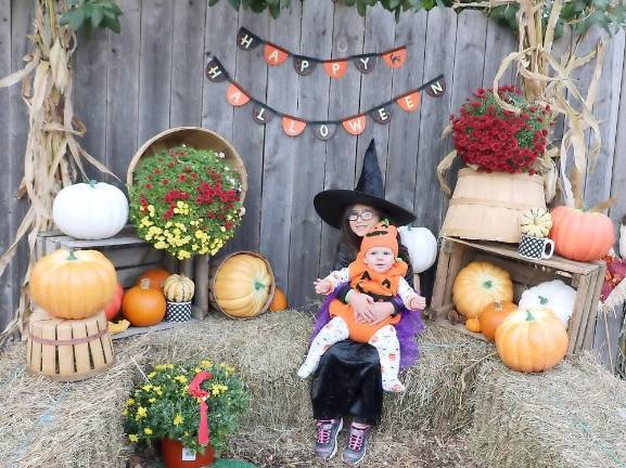 Trunk or Treat event raises $1,500 for St. Stephen – St. Edward Elementary School Aria Saghafi, 5, and Cody Lanigan, 7 months, pose in a special set created for visitors to take photos.