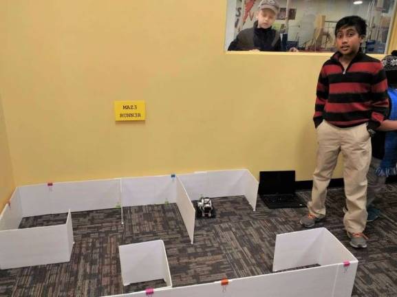 Kids become engineers at Robotics4U Pravin Jegan with his maze-running robot (Photo by Ginny Privitar)