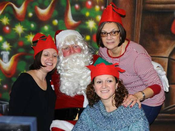 Christmas for Kids in the Village of Florida Santa with several of his elves during a break at last Saturday's Christmas for Kids Breakfast, sponsored by the Knights of Columbus in Florida.