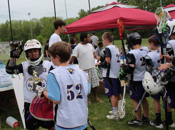 Nothing LAX-adaisical about Warwick Youth Lacrosse Photo by Marie Janiak-Hranitz Connor Meade, the Warwick U13 goalie, collects his championship trophy.