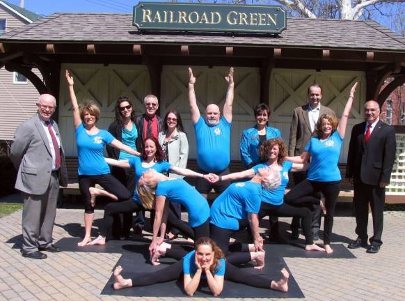 Club Mani Yoga opens on Main Street, Warwick Photo by Roger Gavan On April 26, Warwick Deputy Supervisor James Gerstner and members of the Warwick Valley Chamber of Commerce Board of Directors joined Lisbeth Ryan and her staff at Railroad Green for a unique photo opportunity, far different from the usual ribbon cuttings. Clockwise from center front, Rose Dwyer, instructor and owner of Warwick yoga studio; Margaret Johnson, instructor; Maura Johnson, kids yoga instructor; Loren Welch, instructor and staff nurse; Paul Massie, instructor and owner of Warwick yoga center; Rosita Gilsenan, instructor; Lisbeth Ryan, instructor and owner of Club Mani yoga and Fran Cox, instructor. Chamber Board Members rear from left, Treasurer Doug Stage, Vikki Garby, Executive Director Michael Johndrow, Susan Ronga, Chamber President Paul Rafanello and Town of Warwick Deputy Supervisor James Gerstner.