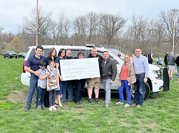 Giant Chocolate Bunny brings $2070 to Warwick Fire Dept. Warwick Chocolate Company owner Viktor Gelman ( far left) announced that the Giant Chocolate Bunny raffle raised $2070 for the Warwick Fire Department. Here is the presentation of the big check. Gelman congratulates the winners and thanks all who participated.