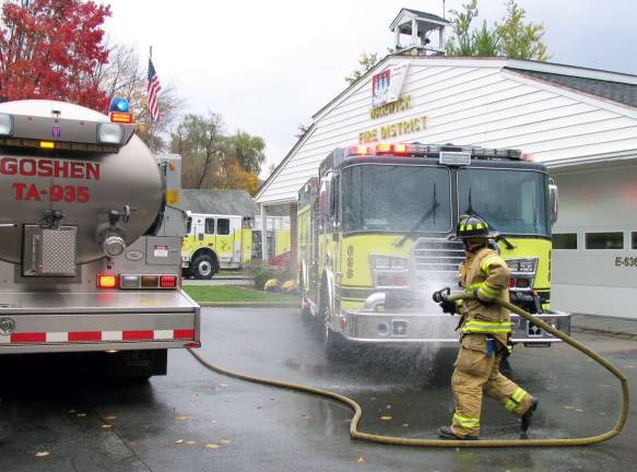 WFD celebrates new truck with wet down Photo by Roger Gavan Fire trucks and crews from surrounding areas, like this one from Goshen, joined in the wet down and the open house celebration of Warwick's new fire engine purchased for Engine 3 Company fire station on South Street Extension.
