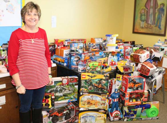 Warwick Ecumenical Food Pantry distributes more than 200 Christmas food baskets The toy lady - Volunteer Debbie Moran was in charge of distributing the toys.
