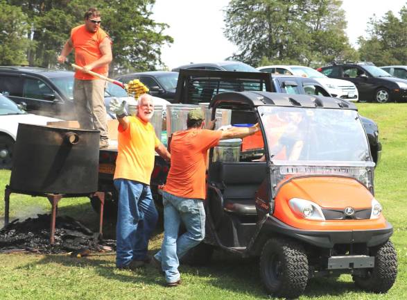 Senior barbecue draws 500 to Union Corners Town Park Members of the Town of Warwick Department of Public Works load ears of corn they had cooked in a huge kettle on an open fire.