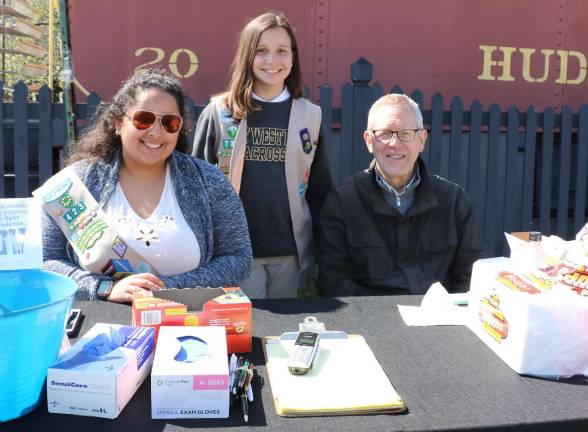 Photos by Roger Gavan After six years, Julia Vargas (left), who is heading off to college, is turning over the Operation Clean Sweep responsibility to Elizabeth Verboys (center), a member of Girl Scout Troop 733. Warwick Valley Chamber of Commerce Ececutive Director Michael Johndrow (right) praised Vargas for her many years of dedication and he thanked Verboys for accepting the challenge.