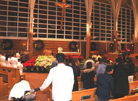 Spanish Mass at St. Stephen's held to celebrate El Dia De Reyes, the Epiphany On Saturday evening, Jan. 6, members of the local Latino community joined together at a Mass said in Spanish to celebrate the Epiphany at the Church of St. Stephen, the First Martyr, in Warwick. The celebrant this year was the Rev. Richard Marrano, the Parochial Vicar at St Stephen’s. The musicians (far right) were Rocco Battista and Katherine Petrillo Klein.