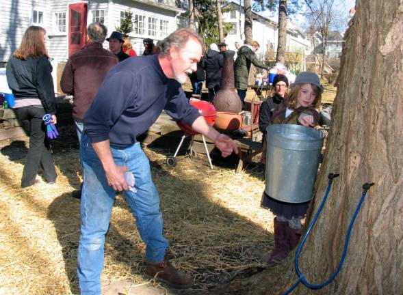Oh, how sweet it is Photo by Roger Gavan On Sunday, Feb. 26, Warwick resident Pat Gallagher, owner of Gallagher Solar Thermal, threw a party in his back yard with live music and refreshments to celebrate the annual tapping of his maple trees. He is pictured here explaining the maple tree-tapping process to Riley Dunleavy, 7.