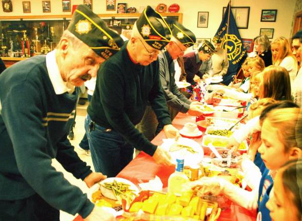 From young to old: Thanks Photo by Ed Bailey Turkey and all the trimmings, along with many side dishes and desserts, were served to the veterans by the Girl Scouts.
