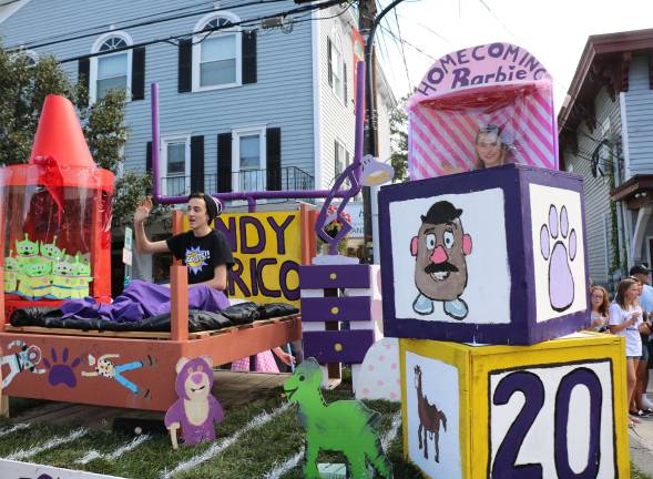 Crowds enjoy Homecoming Day Parade on Main Street The sophomore float's theme was "Toy Story," a computer-animated buddy comedy adventure film produced by Pixar Animation Studios.