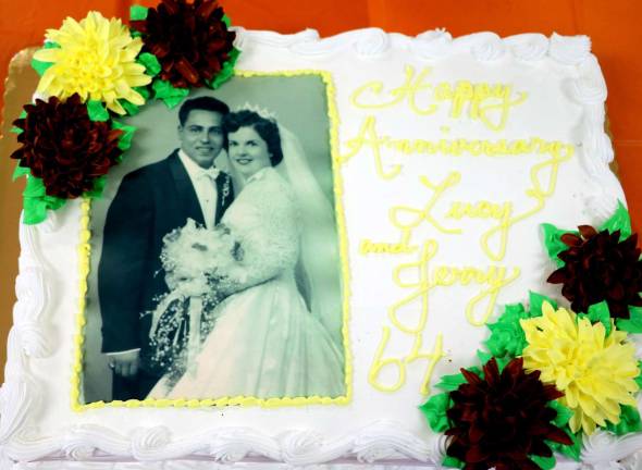 During the celebration the couple cut a special anniversary cake featuring a photograph taken on their wedding day 64 years ago.
