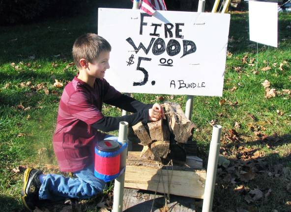 Theft or honest mistake Photo by Roger Gavan Back in business, Devin Pavlick, 7, ties another bundle of wood for sale.