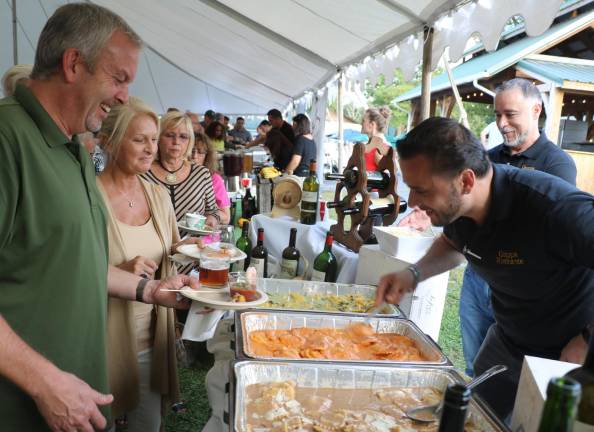 Everyone gathered in the huge tent and on the patio to mingle with friends and sample gourmet dishes and wine provided by 26 vendors