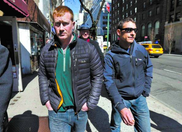 A leap of 104 stories James Brady, left, and Andrew Rossig, right, two parachutists who jumped from One World Trader Center in September 2013, are accompanied by attorney Timothy Parlatore to surrender to police, in New York on March 24. Monday's arrests come eight days after a 16-year-old was arrested on charges of climbing up to the top of the nation's biggest skyscraper. Police said they were looking for two parachutists seen floating near the building Sept. 30. The defense attorneys say three accused jumpers and an alleged accomplice on the ground are expecting to face felony burglary charges. The attorneys say the defendants are experienced BASE jumpers, the acronym stands for "building, span, antenna, earth." The lawyers say the men took care to keep from endangering anyone. Rossig is a graduate of Warwick Valley High School. AP Photo/Richard Drew
