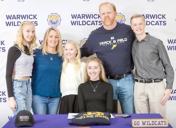 Warwick Valley High School senior Katherine Smith signs a National Letter of Intent to attend the University of Notre Dame on Dec. 23. Smith will compete as a mid-distance runner at Notre Dame. She is surrounded by her family, including her parents Karen and Brian, her brother Sean and sisters Erin and Reagan following the signing ceremony. Photo by WVCSD Communications Specialist Tom Bushey.