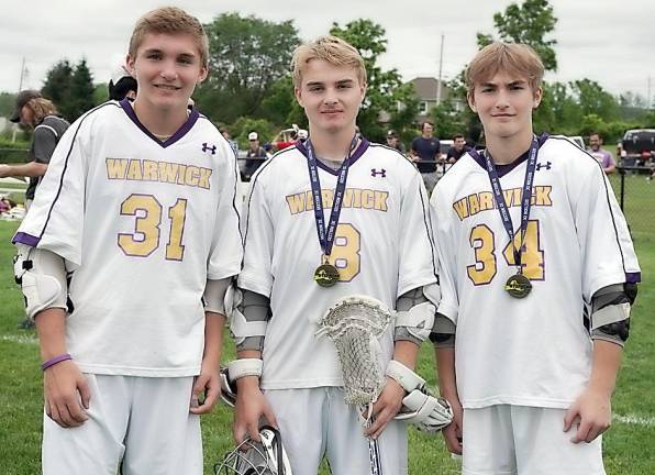 Johnny, Luke and Michael Accardo with their medals after playing together for the first time this year.