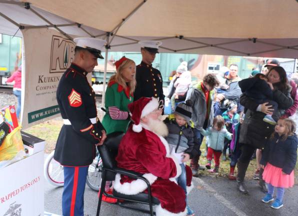 On Sunday Santa was also on board with the elves and a Marine Corps detachment. They spent almost an hour out of the rain and under a tent posing for photographs with children and families.