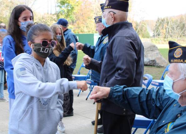 Fist-bumping with veterans, many S.S. Seward students thanked each of them for their sacrifice for the country.