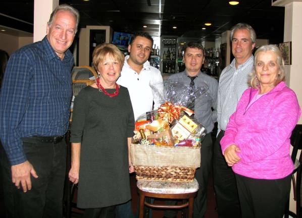 Holiday raffle to support Backpack Snack Attack program raises nearly $2,600 Photo by Roger Gavan A drawing was held Nov. 20 at La Piazza Wine Bar on Railroad Avenue to select the winners of the 2013 Backpack Snack Attack Holiday Raffle. From left, Backpack Snack Attack volunteer Len Singer, Program Executive Director Shirley Puett, Tony Sylaj, owner of Grappa Ristorante and La Piazza, co-owner Nick Ahmetaj, Leo R. Kaytes and Leslie Culkin from Leo Kaytes Ford.