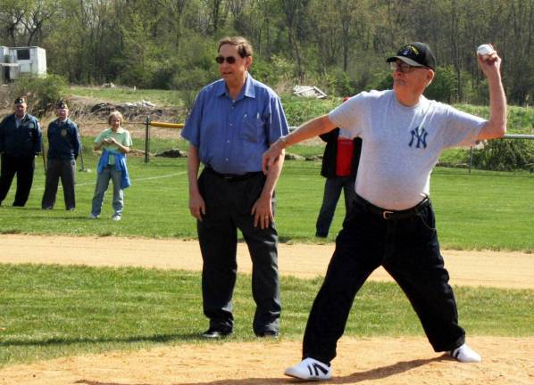 Florida celebrates half a century of playing ball Village of Florida Historian William Pillmeier Jr. throws out the first pitch to open the Florida Little League season, now in its 50th year. Florida Mayor Jim Pawliczek looks on; he would later throw out the ceremonial first softball pitch. Photos by Andrea Cushing