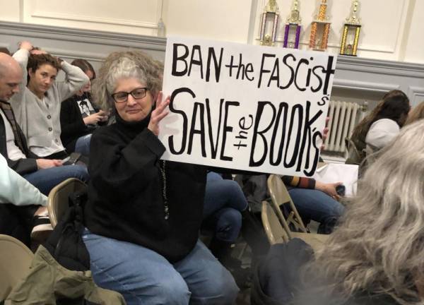 ‘Bigots’ vs. ‘groomers’ Simonetta Jean of Sparta holds up a sign at the Board of Education meeting Thursday, Feb. 23.