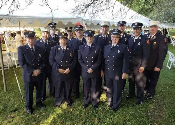 The Warwick Historical Society honored the Warwick Fire Department in its 150th anniversary at its Under the Tent Party in August. Begnning in the front row, from left to right, are: Barry O’Neill, Melissa Stevens, Marianne Petersen and Debra Schweikart. Back row: James Gerstner, Brian Wood, Robyn Kittner, Tom Gove, Danny Schweikart, Rob Pappad, Ryan Reilly and Mike Contaxis.