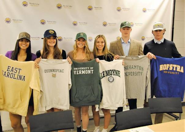 From Left to right: Warwick’s Skyler Blanton (ECU), Paige Girardi (Quinnipiac), Kiera Larney (Vermont), Stephanie Malota (LeMoyne), Jackson Mitchell (Binghamton) and Ryan McLaughlin (Hofstra) show off their new school colors at the Press Conference on Warwick HS Campus November 10.