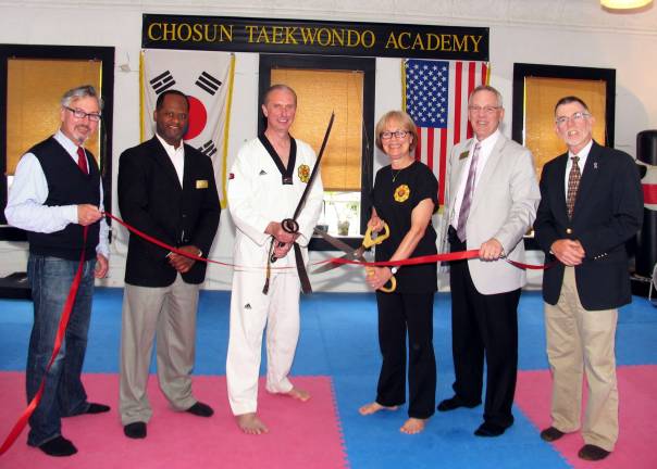 Chosun Taekwondo celebrates fifteenth anniversary Photo by Roger Gavan On Wednesday, May 23, public and business representatives joined Doug and Patricia Cook for a ribbon-cutting ceremony to celebrate the 15th anniversary of Chosun Taekwondo Academy. From left are: Warwick Mayor Michael Newhard, Cedric Glasper, president of the Warwick Valley Chamber of Commerce, Master Doug Cook, Patricia Cook, Chamber Executive Director Michael Johndrow and Town of Warwick Supervisor Michael Sweeton.