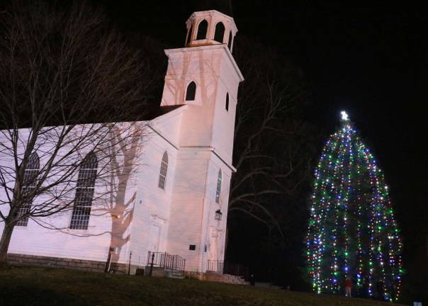 Photos by Roger Gavan The Historical Society of the Town of Warwick has helped the Warwick Fire Department continue its long tradition by graciously providing the magnificent evergreen, just outside its Old School Baptist MeetingHouse.
