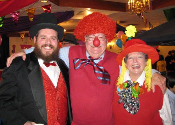 Chabad offers grand Superhero Purim Party on eb. 28 Rabbi Pesach Burston, director of Chabad of Orange County, pictured with Chabad President Gil and Phyllis Goetz at a previous Purim Gala, invites the community to a Superhero Purim Party on Feb. 28.
