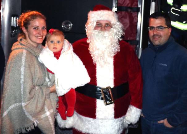 Santa was happy to pose for photos with children and families like Pauls and Melissa Maass with their daughter Leila Jane, 6 months.