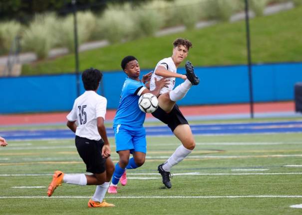 Crusader Ibrahim Cela keeps the ball away from the Middie player.