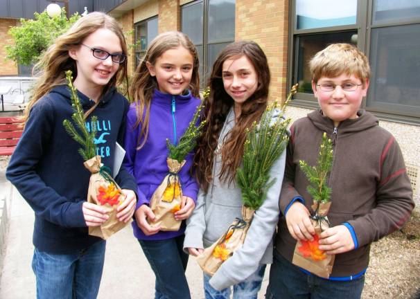 Warwick Valley Gardeners sponsor Arbor Day celebration at Sanfordville Elementary School Photos by Roger Gavan Every student received a tree for planting. From left, Ian Murtagh, Natalie Parasehiv, Emma Jakubik and Daniel Bilezikian.