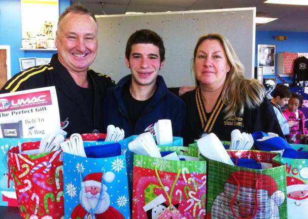 The community spirit kicks in Among a number of community initiatives this holiday season, UMAC is offering a special holiday gift a ìBelt in a Bag:î Two weeks of Martial Arts of Kickboxing Classes, a white belt and a drawstring equipment bag for a $5 donation. The money will go toward buying a local family in need a holiday dinner and gifts. Pictured from left to right are: Grand Master Edmund Ciarfella, Master Jason Bender and Master Teresa Ciarfella.