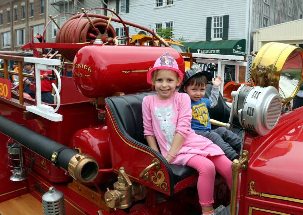 Throughout the morning members of the Warwick Fire Department invited children like Rose Brand, 5, and her brother Matthew, 2, to climb aboard vintage fire apparatus