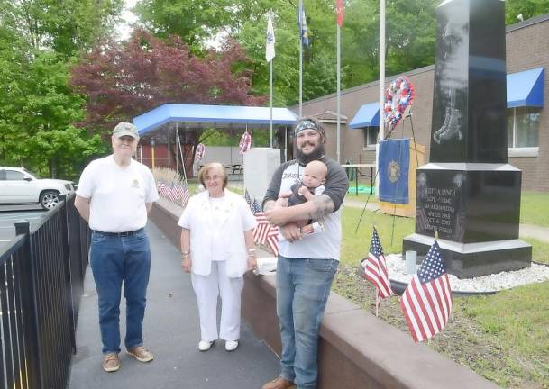 Gold Star Mother Vivian Allen and husband Robert, whose son Lou was killed in Iraq, stand with Jimmy Lynch and his son Scotty. Lynch is the brother of Marine Scott Lynch who was killed in Afghanistan. The statue on the left stands in Scott Lynch's honor. Both families placed wreaths during the program.