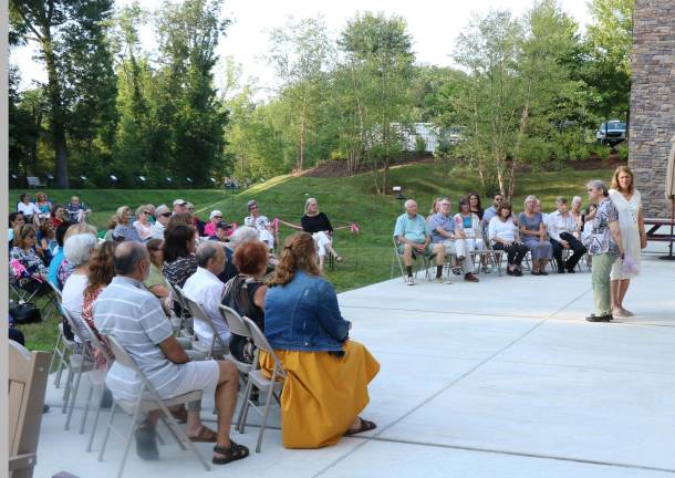 Donna Haley holds the mic for Library Historian Sue Gardner as she tells about the 'keepers.'