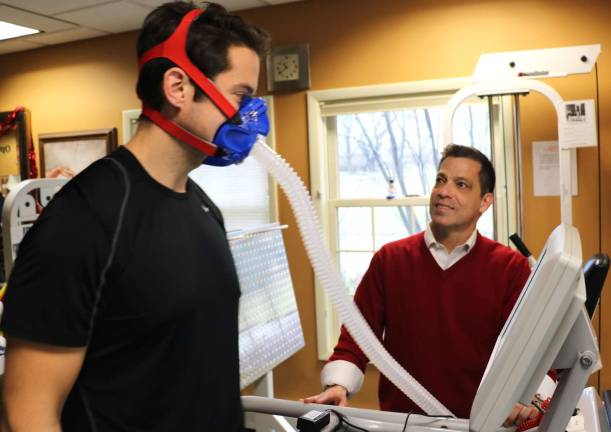 Photo by Roger Gavan Certified Athletic Trainer Nick Clark (left) on the treadmill and Exercise Physiologist Dr. Harry Pino demonstrate the highly specialized equipment called VO2 Max testing that can determine the exact caloric intake your body needs at any given time.