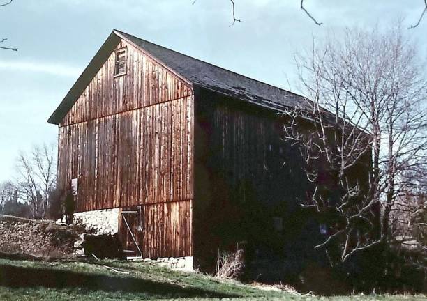 This is the photograph of the weathered barn with a laid stone foundation in a field in Warwick that Steven Carras took while on a drive with a friend when they were in their late teens. “We had ventured north from suburban New Jersey one day on a sort of photographic safari and ended up in Orange County. The back of the photo says simply: near Warwick, NY. I spent many years traveling around the Warwick area hoping to see that barn again - without success,” Carras wrote.